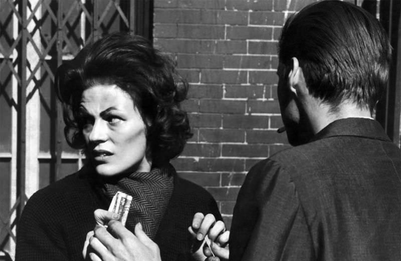 Karen keeping a furtive eye out for detectives, hands a pusher $5 for a bag of heroin.