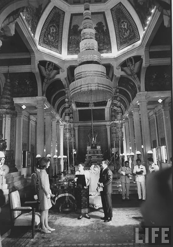 Jackie Kennedy exchanging gifts with Prince Norodom Sihanouk and the Queen Mother in the throne roo of the royal palace 1967