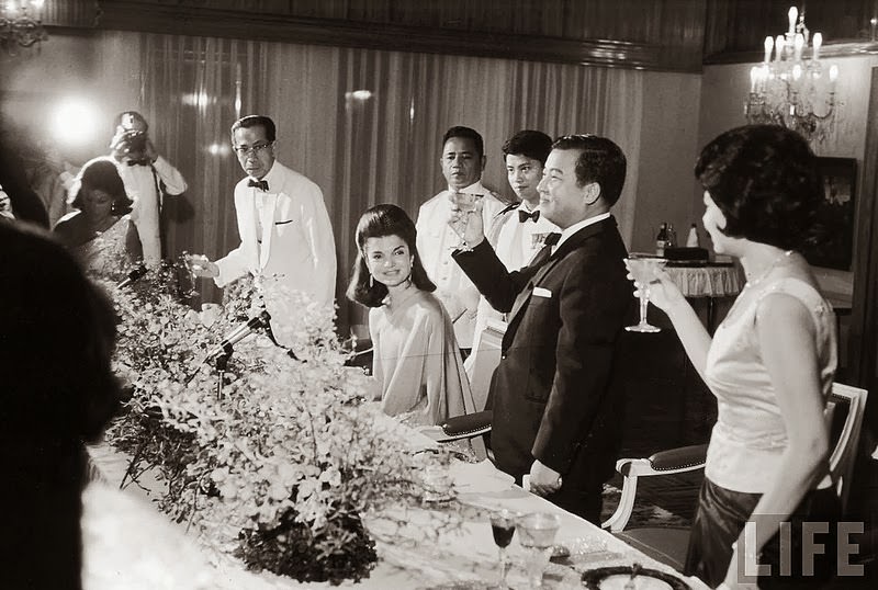 Jackie Kennedy is toasted by Prince Norodom Sihanouk and his wife at the royal palace. Nov 1967