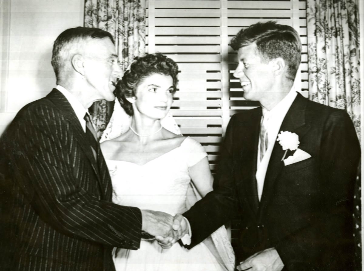 Senator Leverett Saltonstall congratulates Senator John F. Kennedy at the wedding reception, 1953.