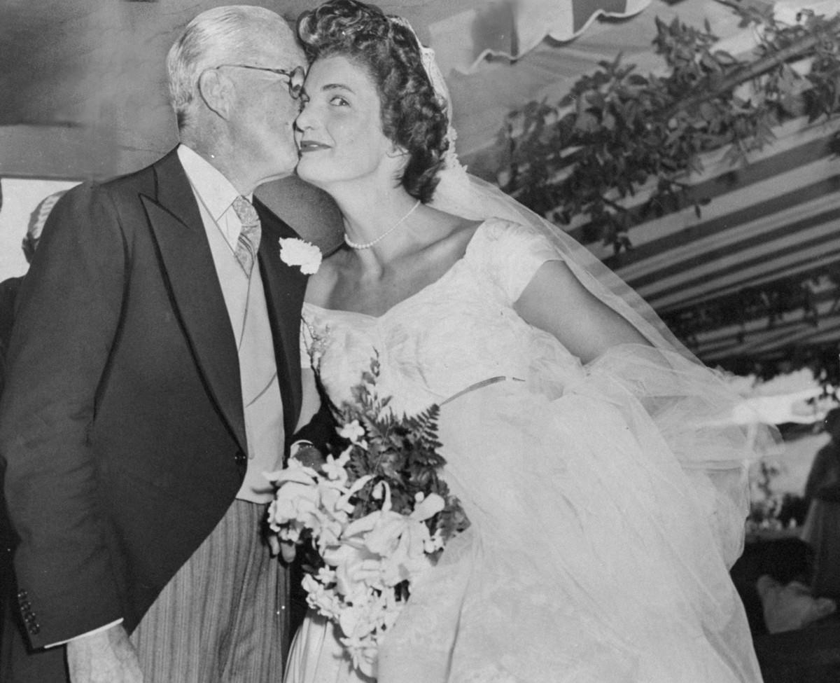 Jacqueline Bouvier Kennedy receives a kiss from her father-in-law, Joseph Kennedy, after her wedding, 1953.