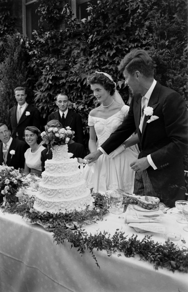 John F. Kennedy and Jacqueline Kennedy cut the cake at their wedding reception, Newport, Rhode Island, 1953.