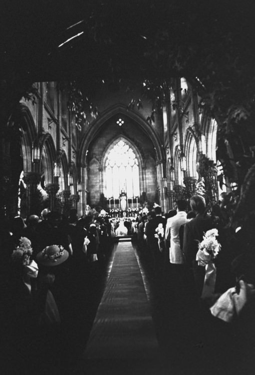 Guests listen to the wedding vows of Senator John F. Kennedy and Jacqueline Bouvier, 1953.