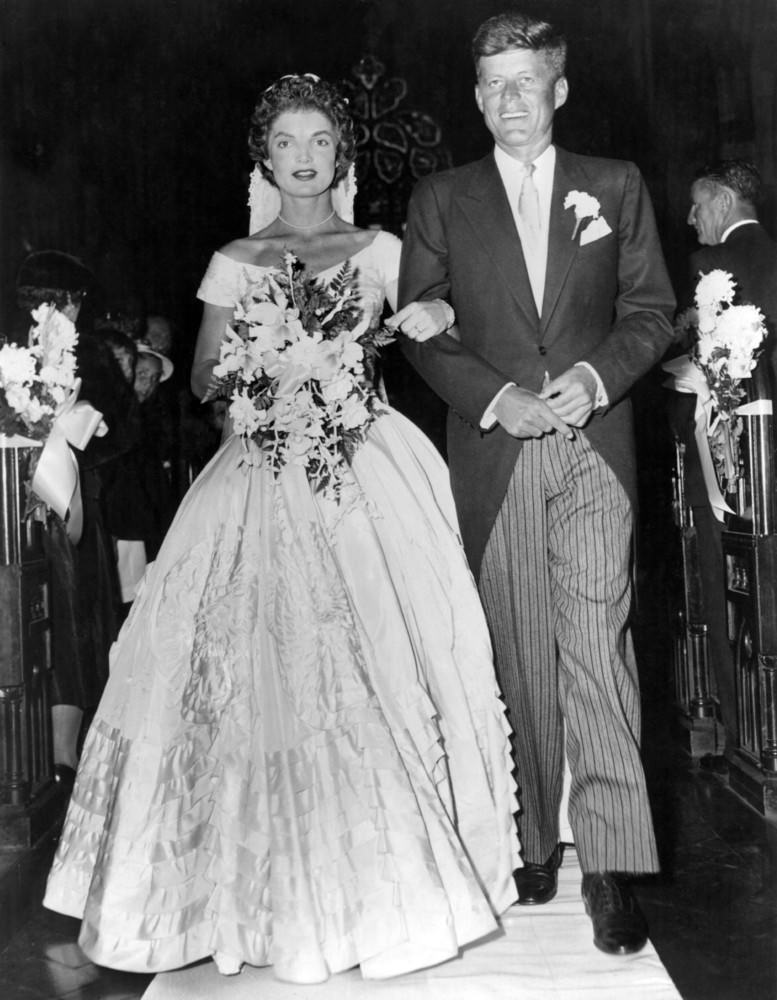 Senator John F. Kennedy escorts his bride Jacqueline Lee Bouvier down the aisle at their wedding in Newport, Rhode Island, 1953.