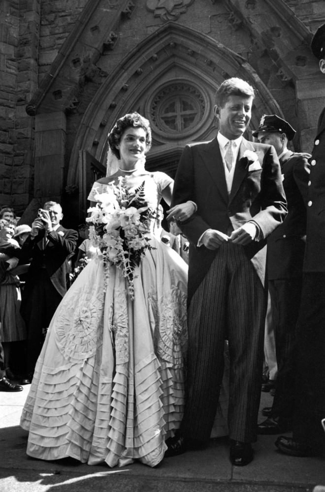 Jacqueline Bouvier in her wedding dress with her husband, Senator John Kennedy, after their wedding ceremony, 1953.