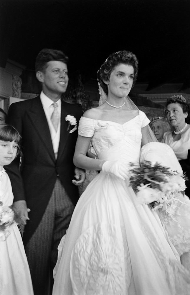 John F. Kennedy and Jacqueline Kennedy stand in front of St. Mary's Church after their wedding ceremony, Newport, Rhode Island, 1953.