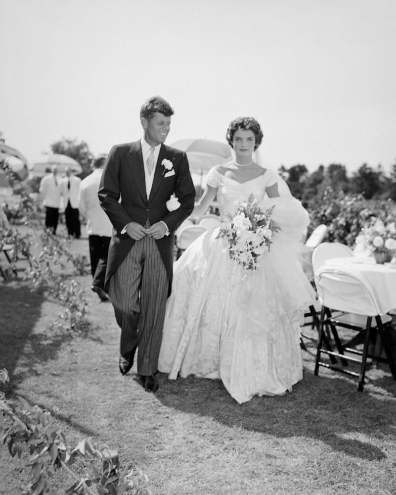 John F. Kennedy and Jacqueline Kennedy at an outdoor reception at their wedding, Newport, Rhode Island, 1953.