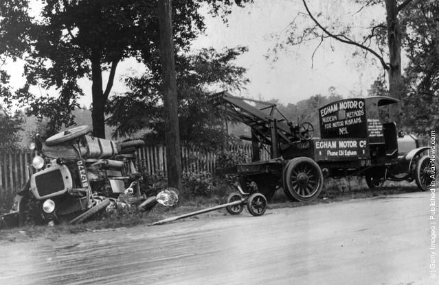 An auto ambulance assisting at a car crash in England, 1925.