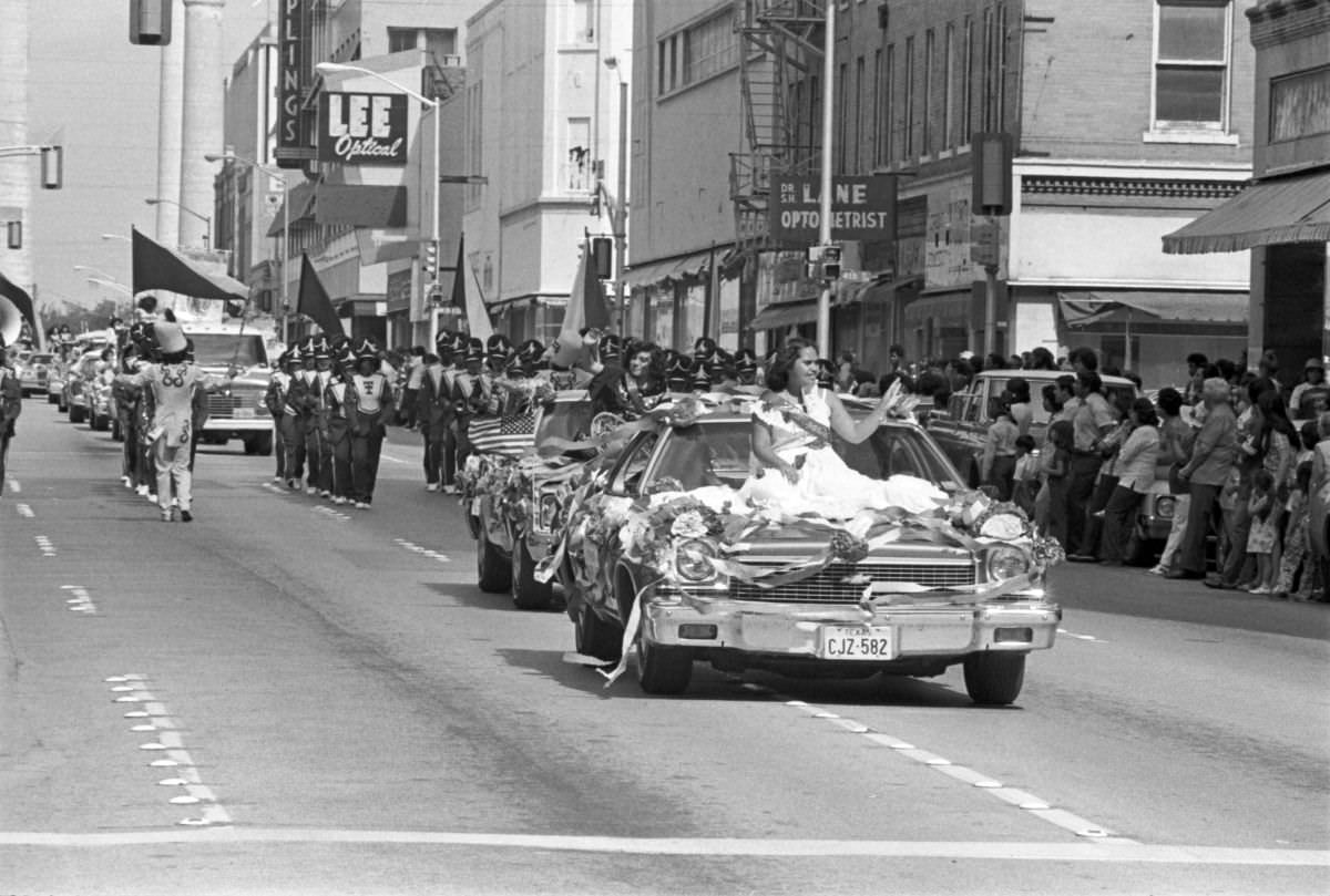 Two candidates for the Mexican Independence Day Fiesta Queen wave to the crowd from cars in Fort Worth, Texas, 1977.
