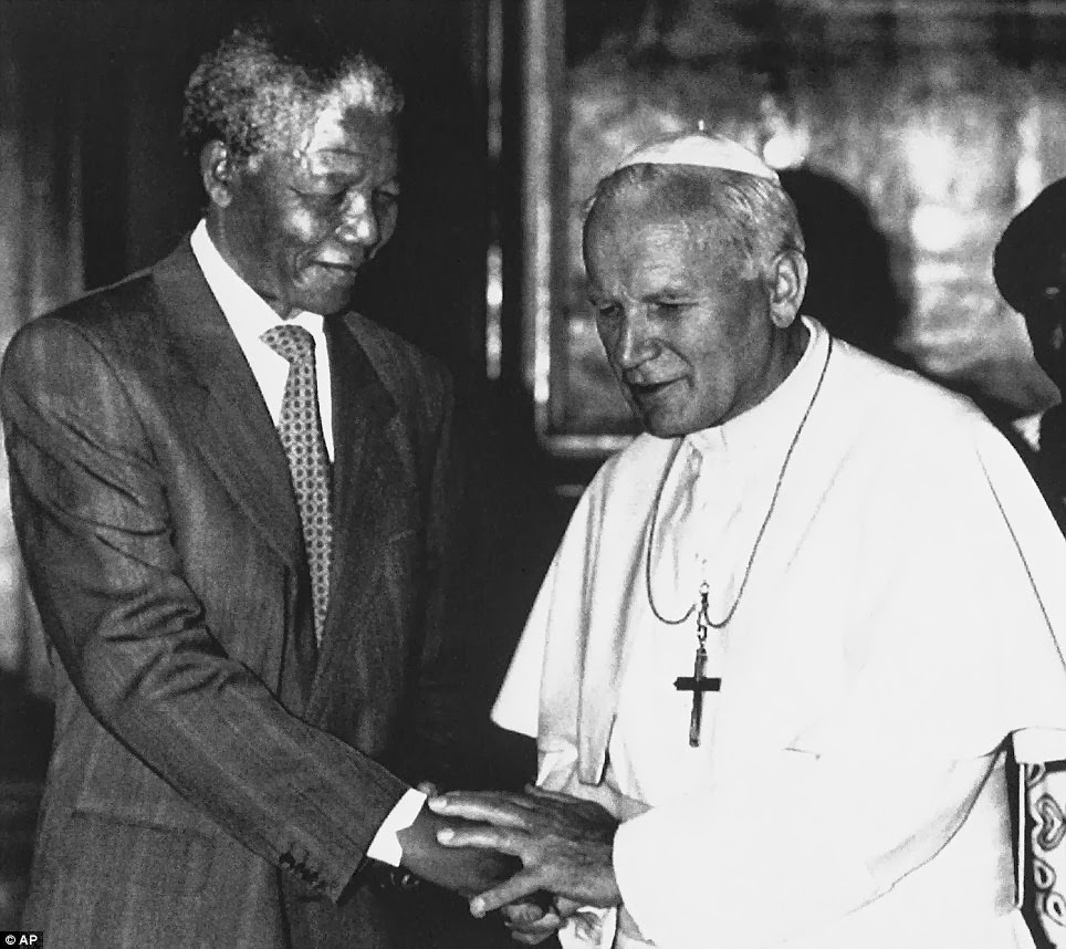 In this June 15, 1990 file photo, Pope John Paul II, right, shakes hands with Nelson Mandela, deputy leader of African National Congress, during a private audience at the Vatican.