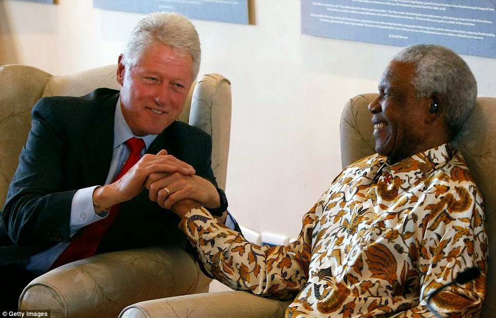 Former U.S. President Bill Clinton (L) embraces former South African President Nelson Mandela following remarks by Clinton during a visit to the Nelson Mandela Foundation July 19, 2007 in Johannesburg.