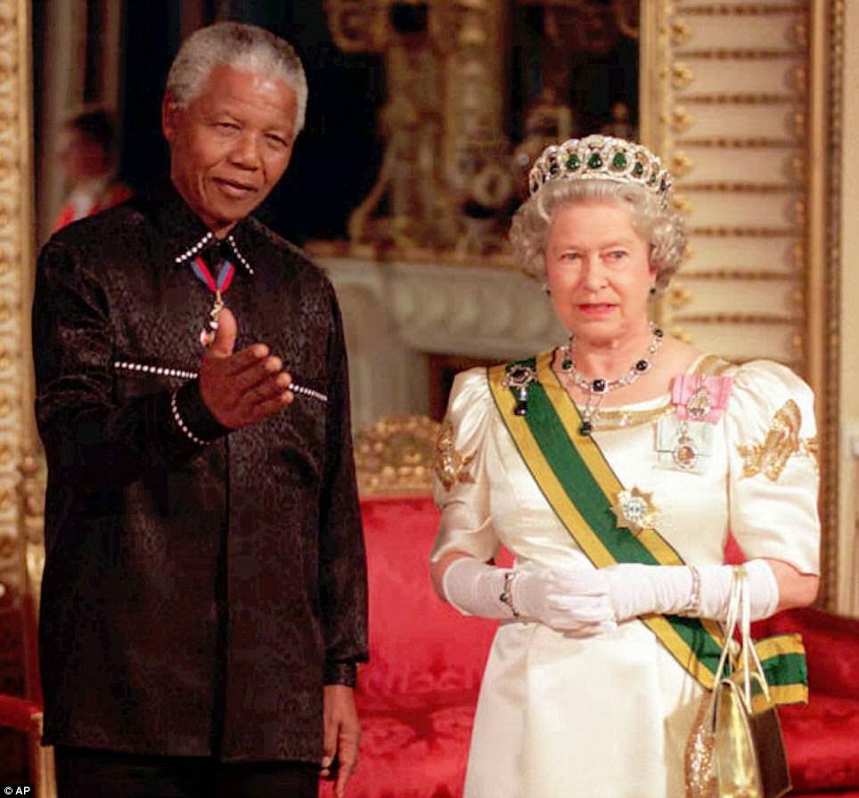 In this July 9, 1996 file photo, South African President Nelson Mandela stands with Queen Elizabeth II on his arrival at Buckingham Palace in London for a state banquet in his honor.