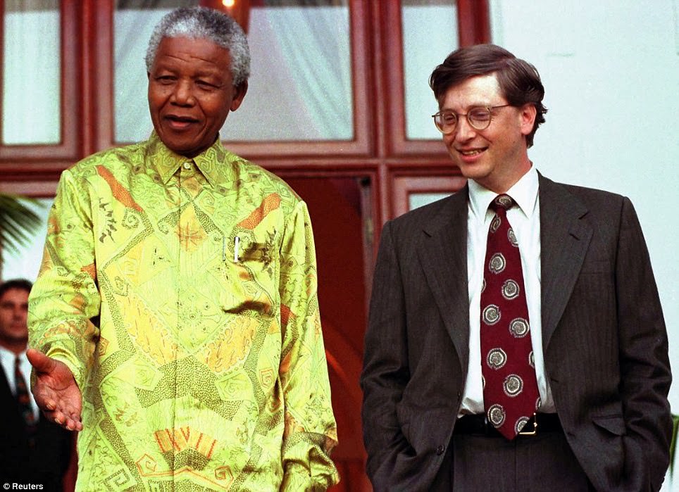 South African President Nelson Mandela (L) shares a joke with Microsoft Chairman Bill Gates after their meeting at Mandela's residence in Cape Town, in this file picture taken March 11, 1997.