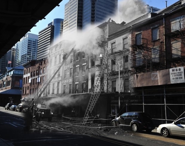 Firefighters put out a fire at the Fulton Fish Market in the South Street Seaport on February 26th, 1961.