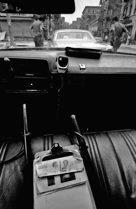 Two officers check a suspicious car with their hands on their revolver handles, 1978.