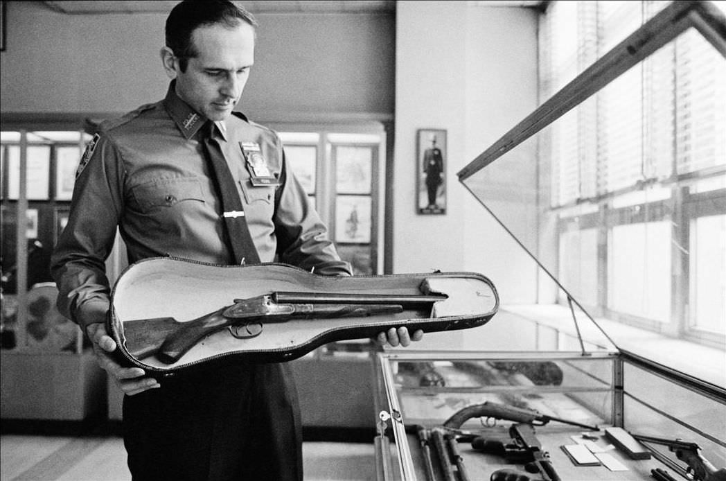 Curator of the Museum of the New York Police holds an artifact of the Romantic era gangster wars, 1979.