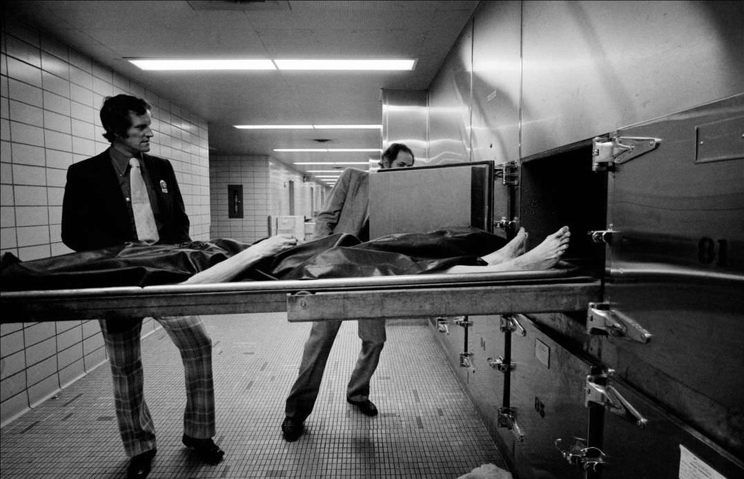 Detectives remove fingerprints from the body in the morgue, 1972.
