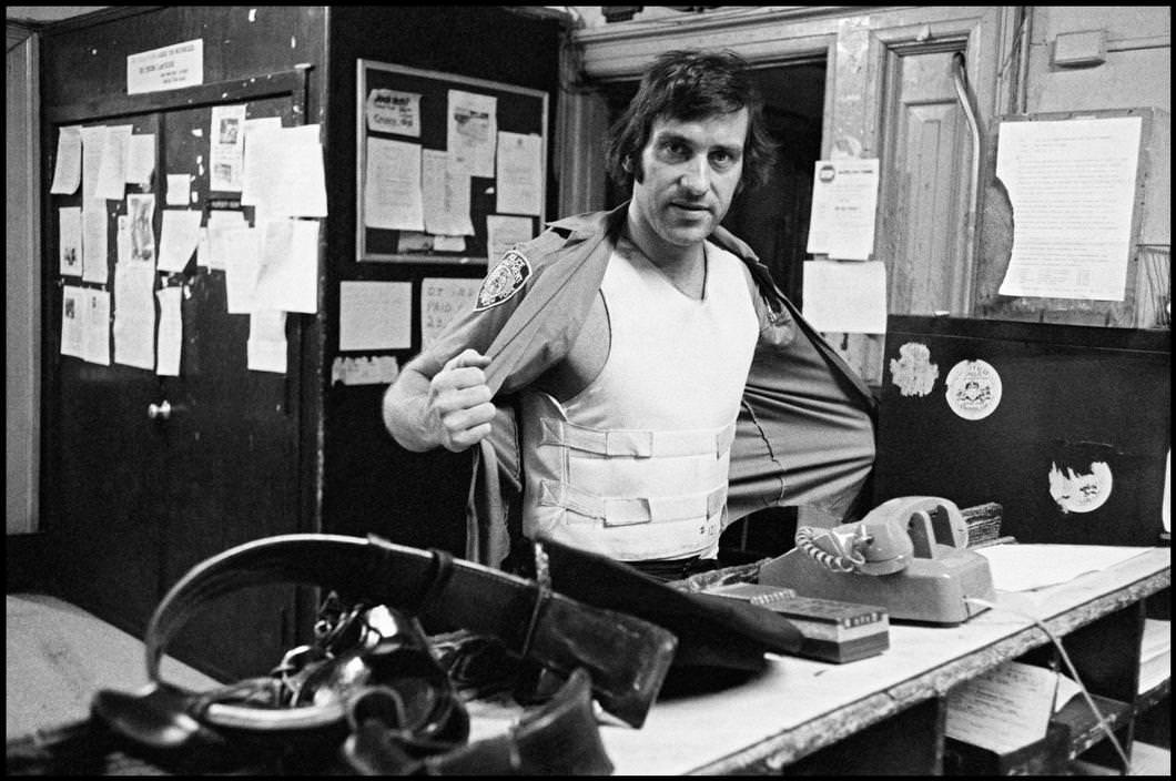 Officer Steve Kreychi wears a bulletproof vest before patrol, 1978.