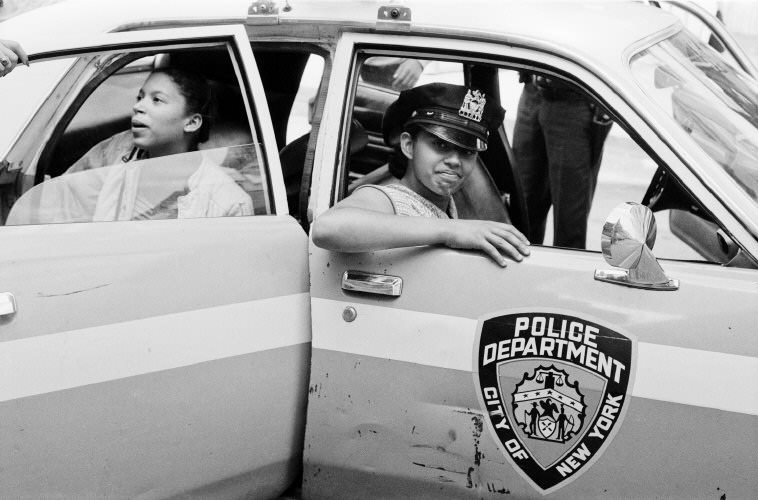 Children play in a police car on one of the hottest days of July, 1979.
