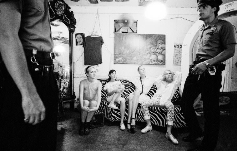 Police officers during a visit to a countercultural clothing boutique, 1979.