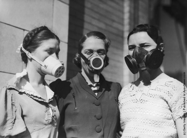 Girls modeling dustbowl masks, 1935.