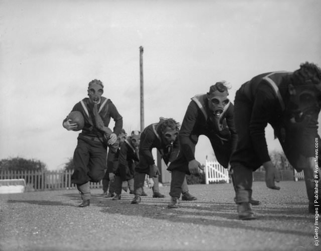 Royal Navy seamen playing ball games in gas masks at the Anti-Gas School, Portsmouth, 1934.