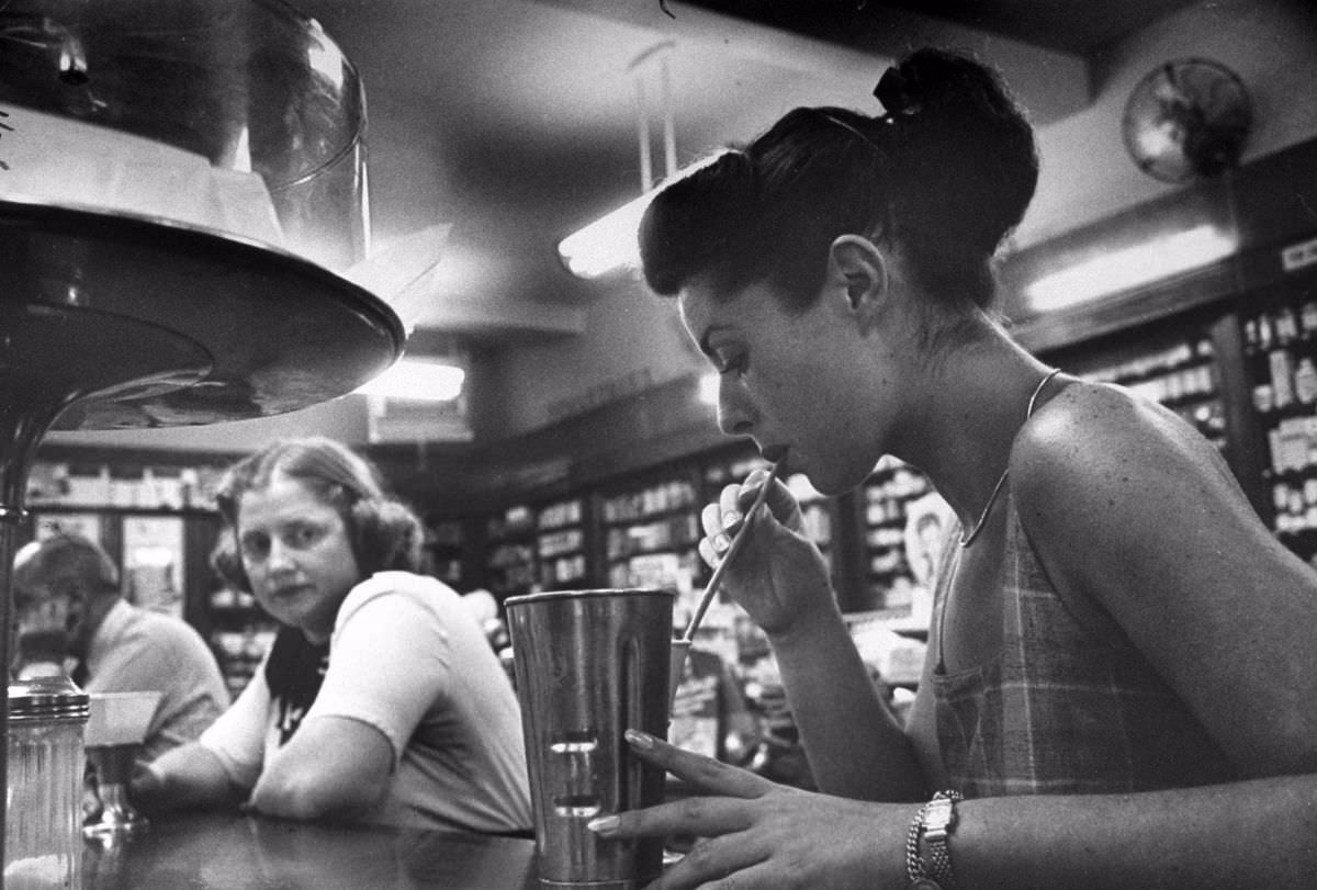 Hungry at drugstore after a day's work earning money for nursing school, Dorothy envies slim girl's milkshake, orders lemonade without sugar for herself.
