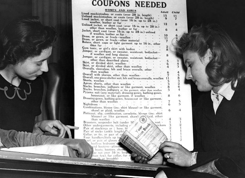 A London shopper studies a coupon chart in a west end store, 1942.