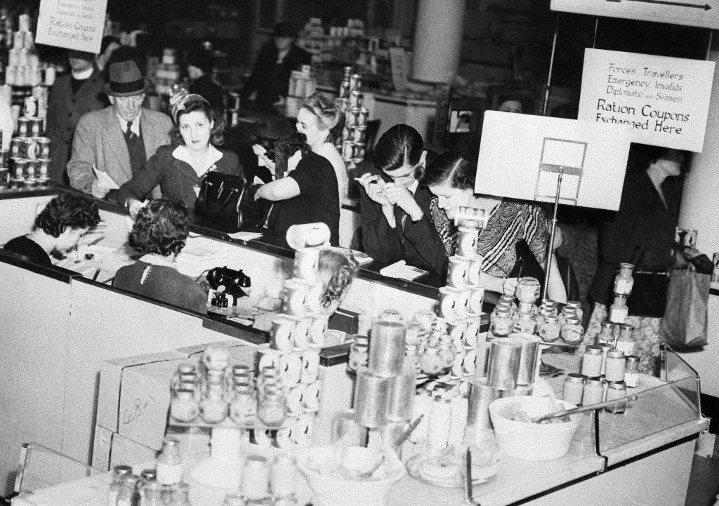 Shoppers line up at a special ration advisory bureau in a big London store, 1945.