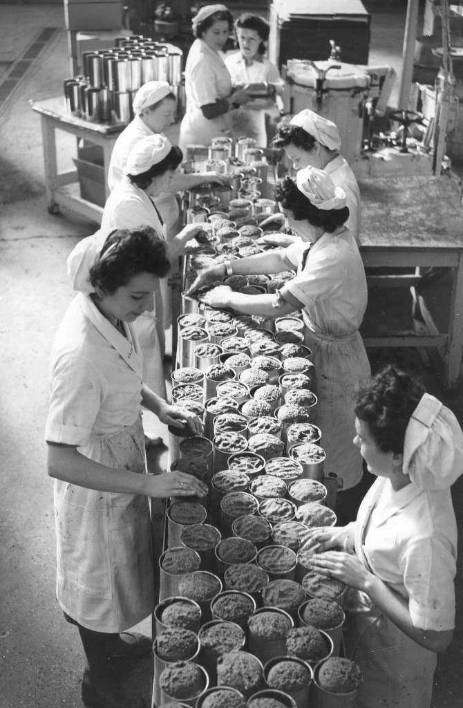 Workers rolling out the whalemeat roll from a conveyor belt at a Slough factory, 1949.