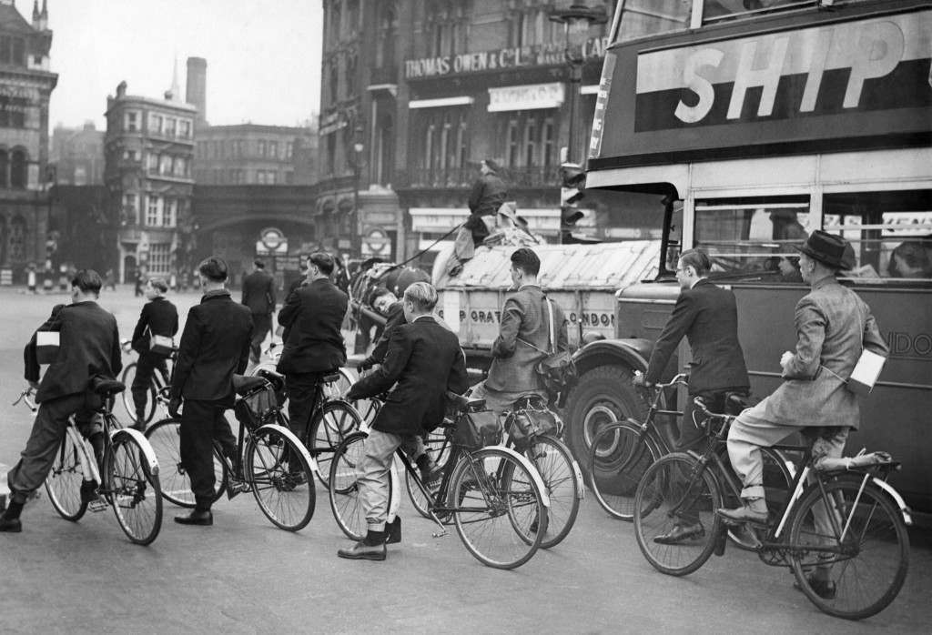 Bicycles, a bus, and a horse-drawn vehicle during the first week of petrol rationing, London, 1939.