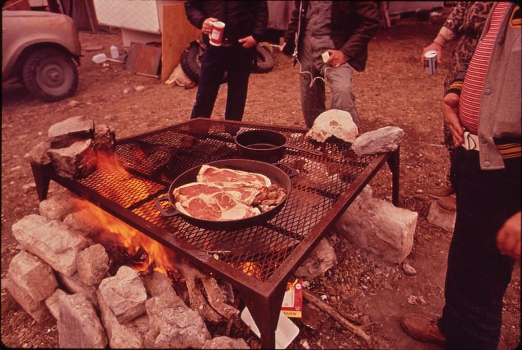 Deer hunters preparing a meal at their permanent camp, 1972.