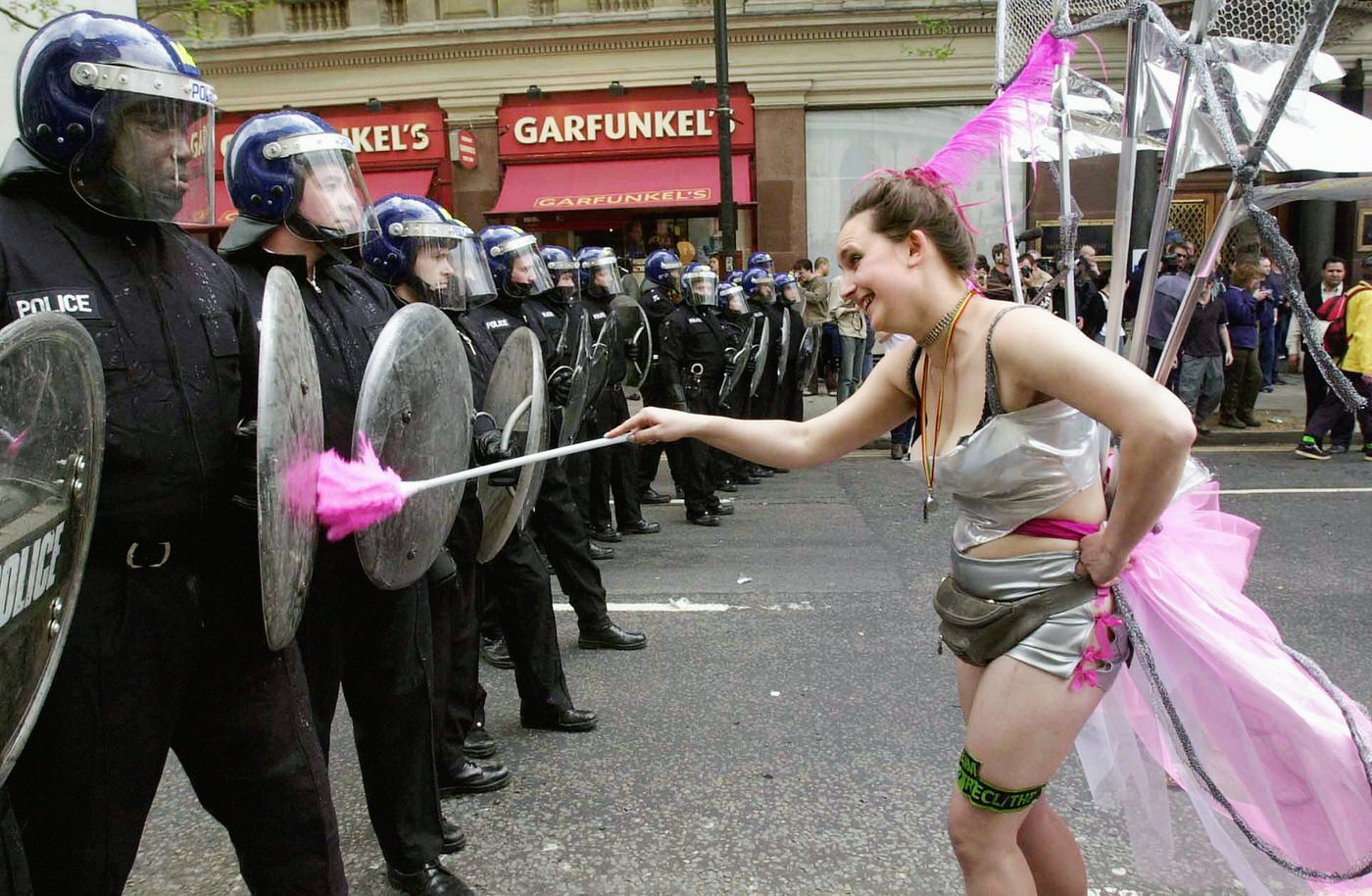 An anti-capitalist demonstrator taunting riot police in Trafalgar Square, 2000.