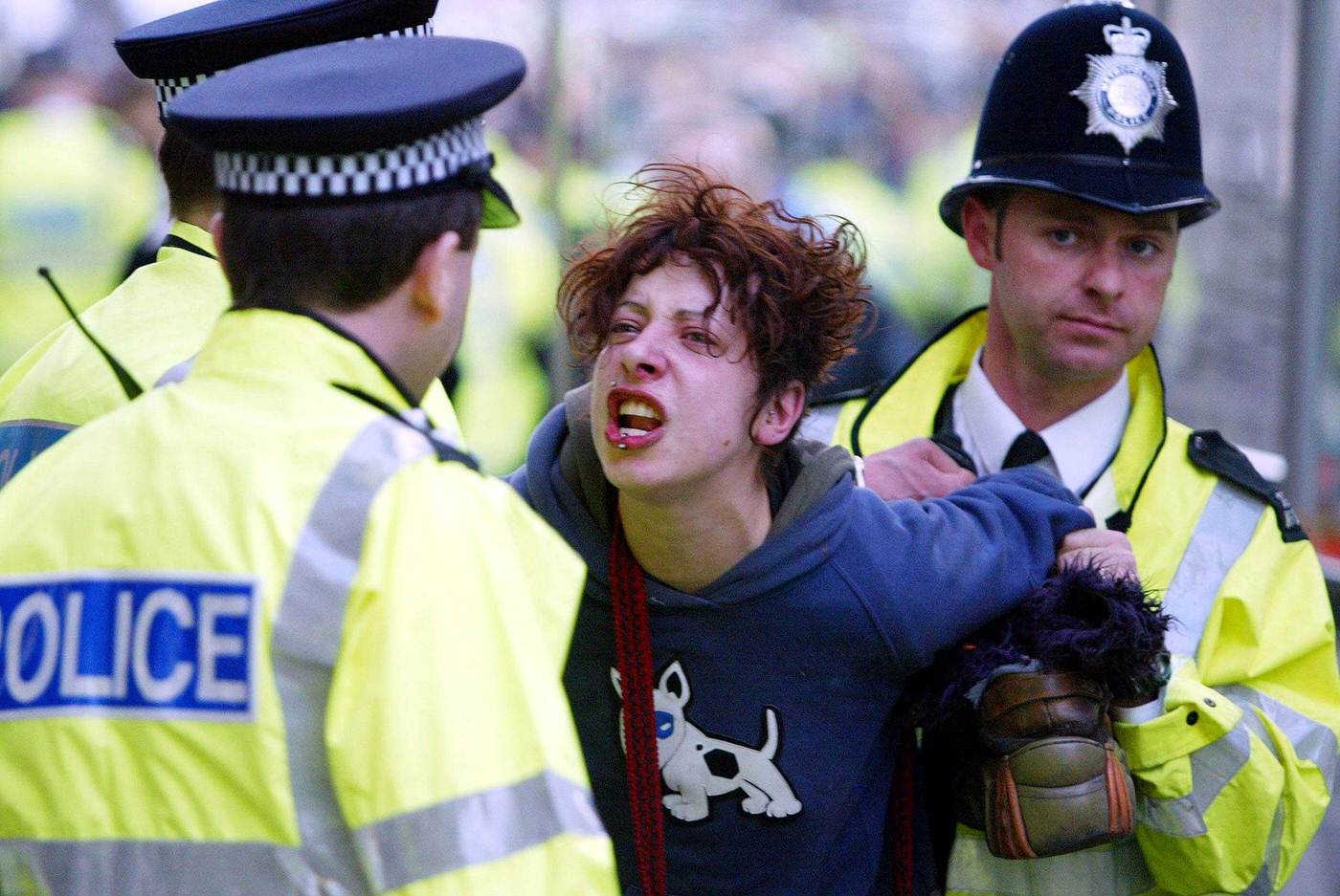 A woman being led away by police during May Day protests in Trafalgar Square, 2003.