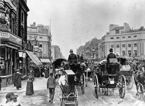 Traffic on Regent Circus (now Oxford Circus), London, facing east along Oxford Street. A man is towing a barrel organ, 1888.