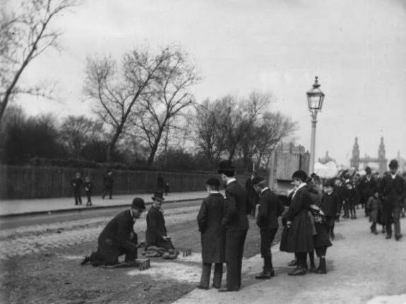 A street game of skittles at the Chelsea Bridge Road Fair, London, 1890.