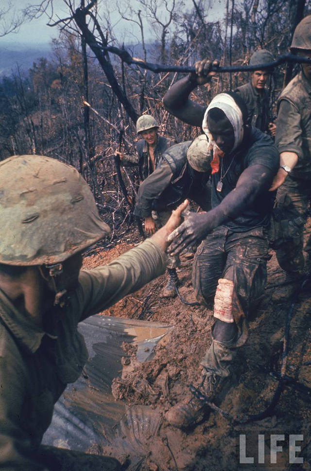 Wounded Marine being helped to an air evacuation point.