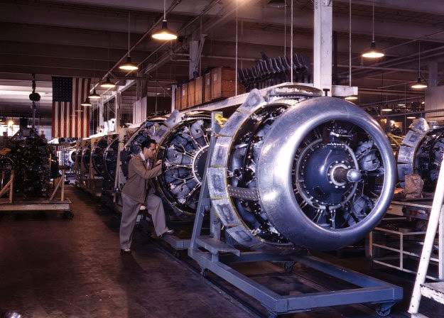 Cowling and control rods are added to B-25 bomber motors at North American Aviation, Inglewood, California, 1942.