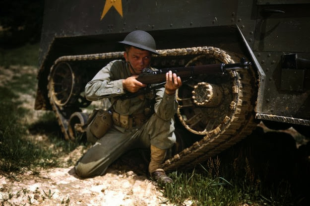 A young armored forces soldier holds a Garand rifle at Fort Knox, Kentucky, 1942.