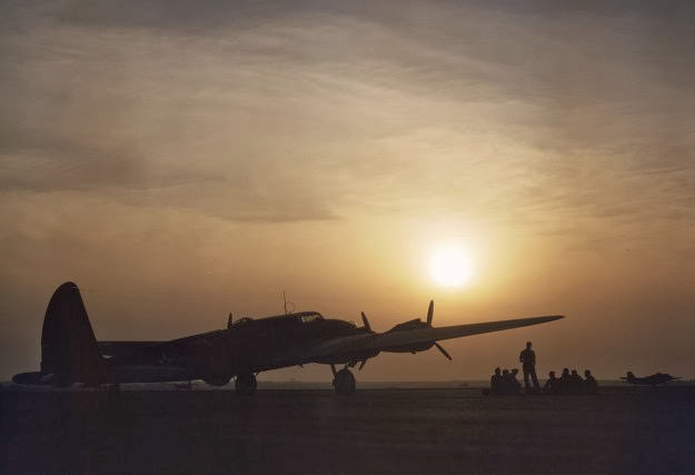 Sunset silhouette of a flying fortress at Langley Field, Virginia, 1942.