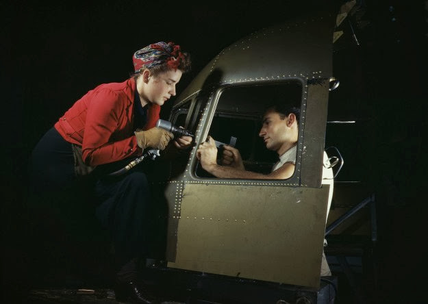 Men and women work on riveting jobs at the Douglas Aircraft plant in Long Beach, California, 1942.