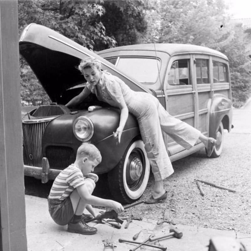Mom fixes the family car, 1940s.