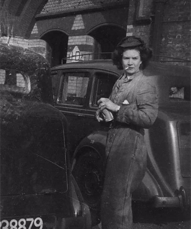 An ATS girl smoking while working on a Humber during WWII.