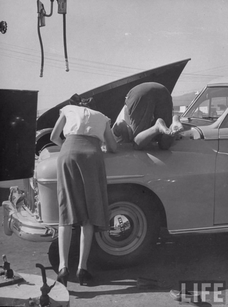 Girls fixing their car, 1950s.