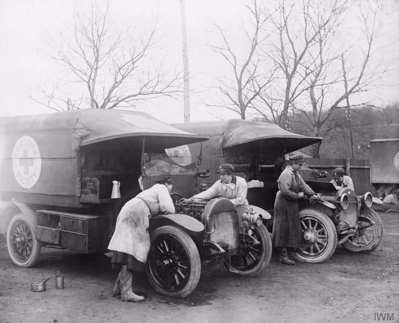 VAD's of the Motor Convoy cleaning cars at base in Etaples, ambulances were donated by the Canadian Red Cross, 1918.