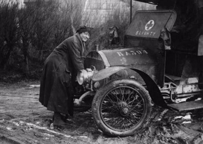 Driver of the First Aid Nursing Yeomanry cranking up an ambulance during World War I.