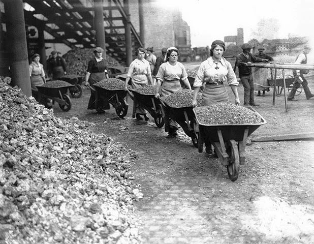 Female construction workers pushing wheelbarrows in Coventry during World War I.