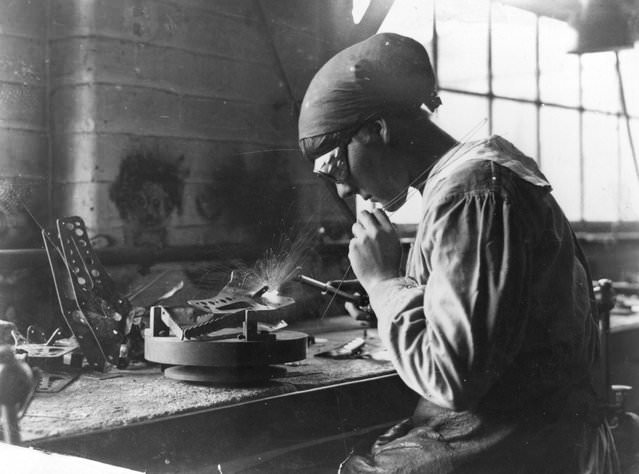 A woman munitions worker welding in an armaments factory, 1915.