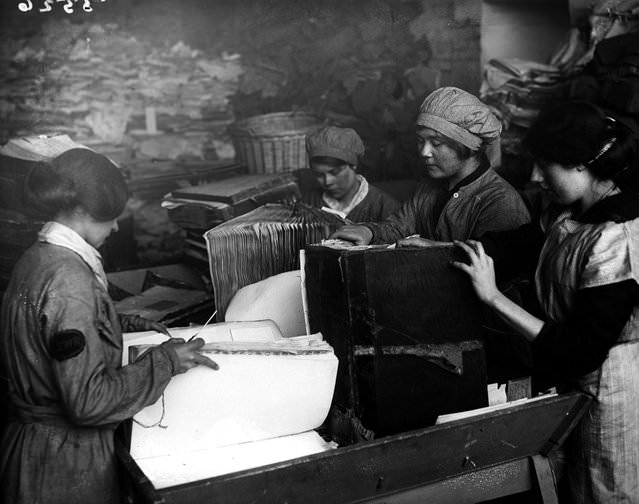 Women pulling apart old ledgers for the London & South West Railway, 1917.