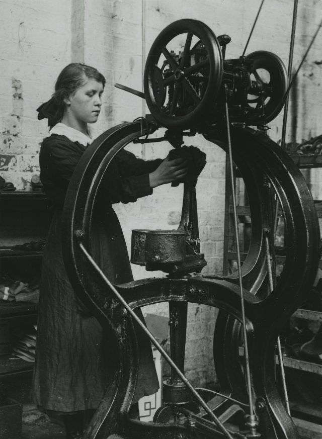 A girl operating a stitching machine in a Leicestershire boot factory.